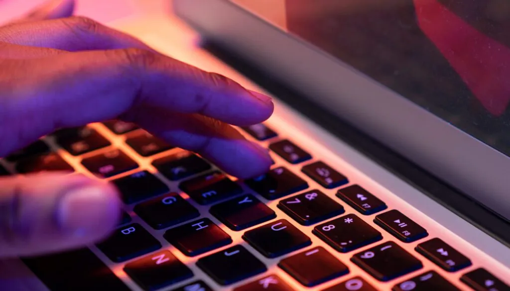 A hand of a software developer working on keyboard